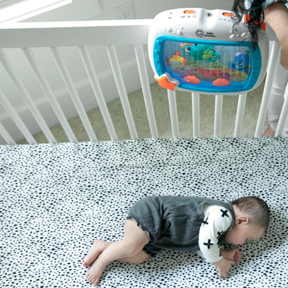 Baby sleeping with Sea Dreams Soother on crib