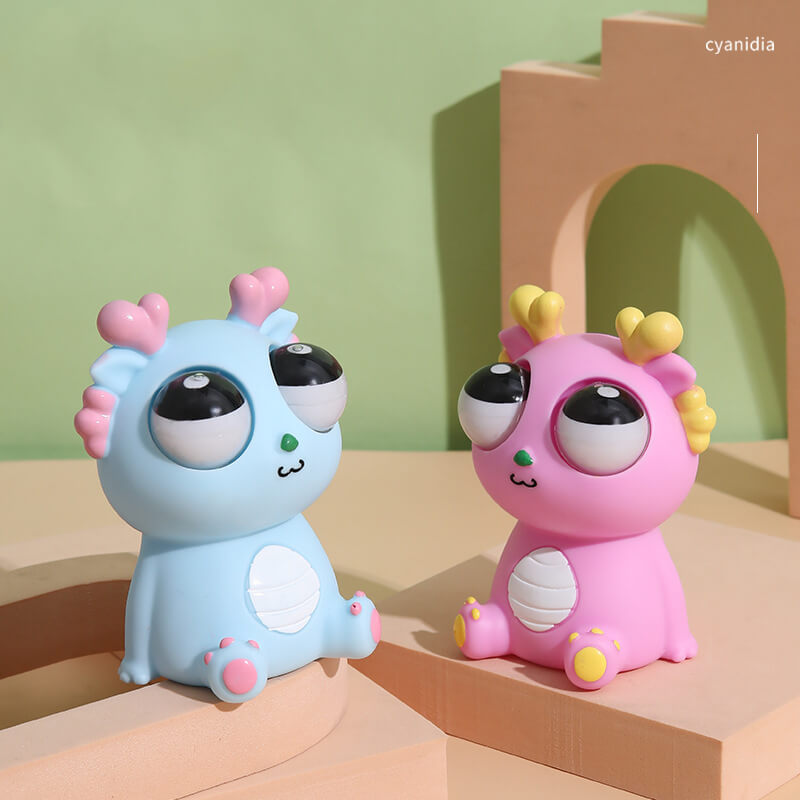 Squeezable dragon toy with popping eyes