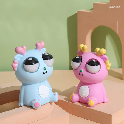 Squeezable dragon toy with popping eyes