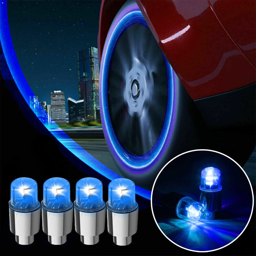 LED tire valve cap lights glowing on car wheel at night