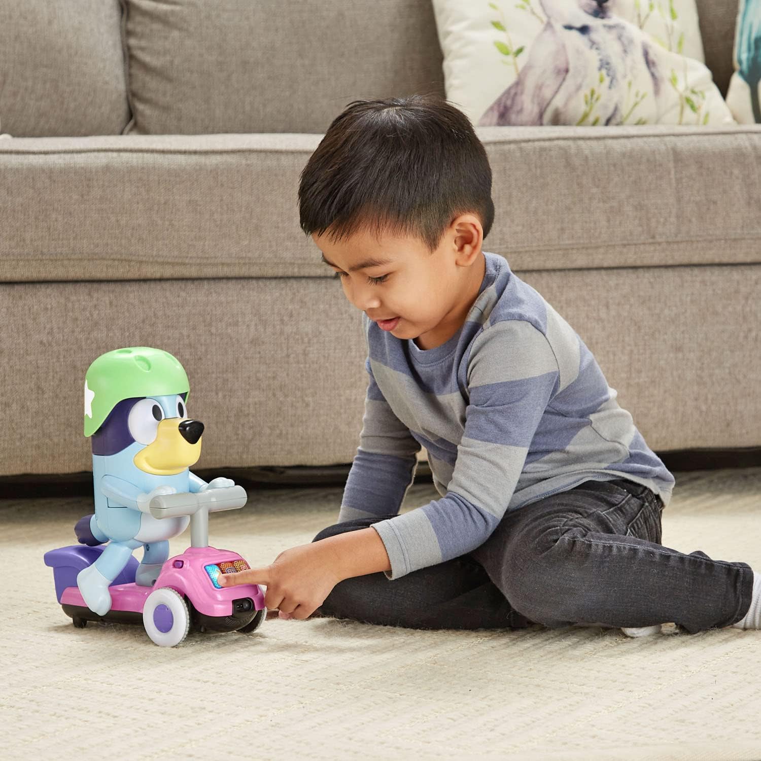 Child playing with VTech Bluey Scooter Time