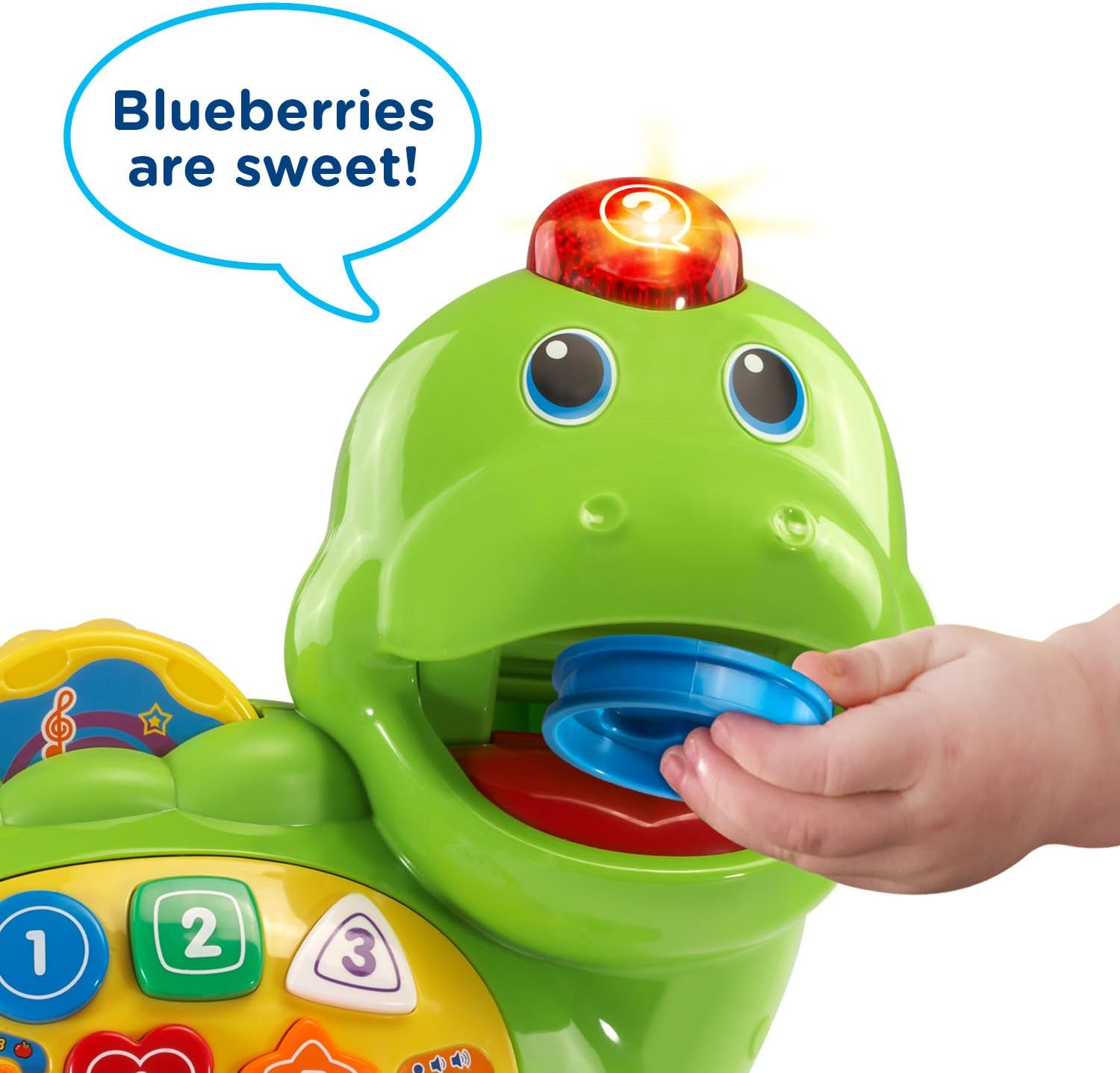 Child feeding food piece to VTech Chomp and Count Dino