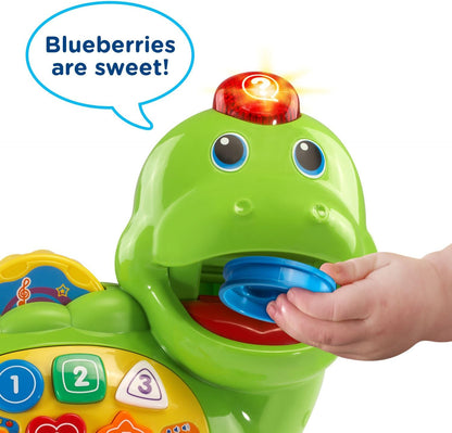 Child feeding food piece to VTech Chomp and Count Dino
